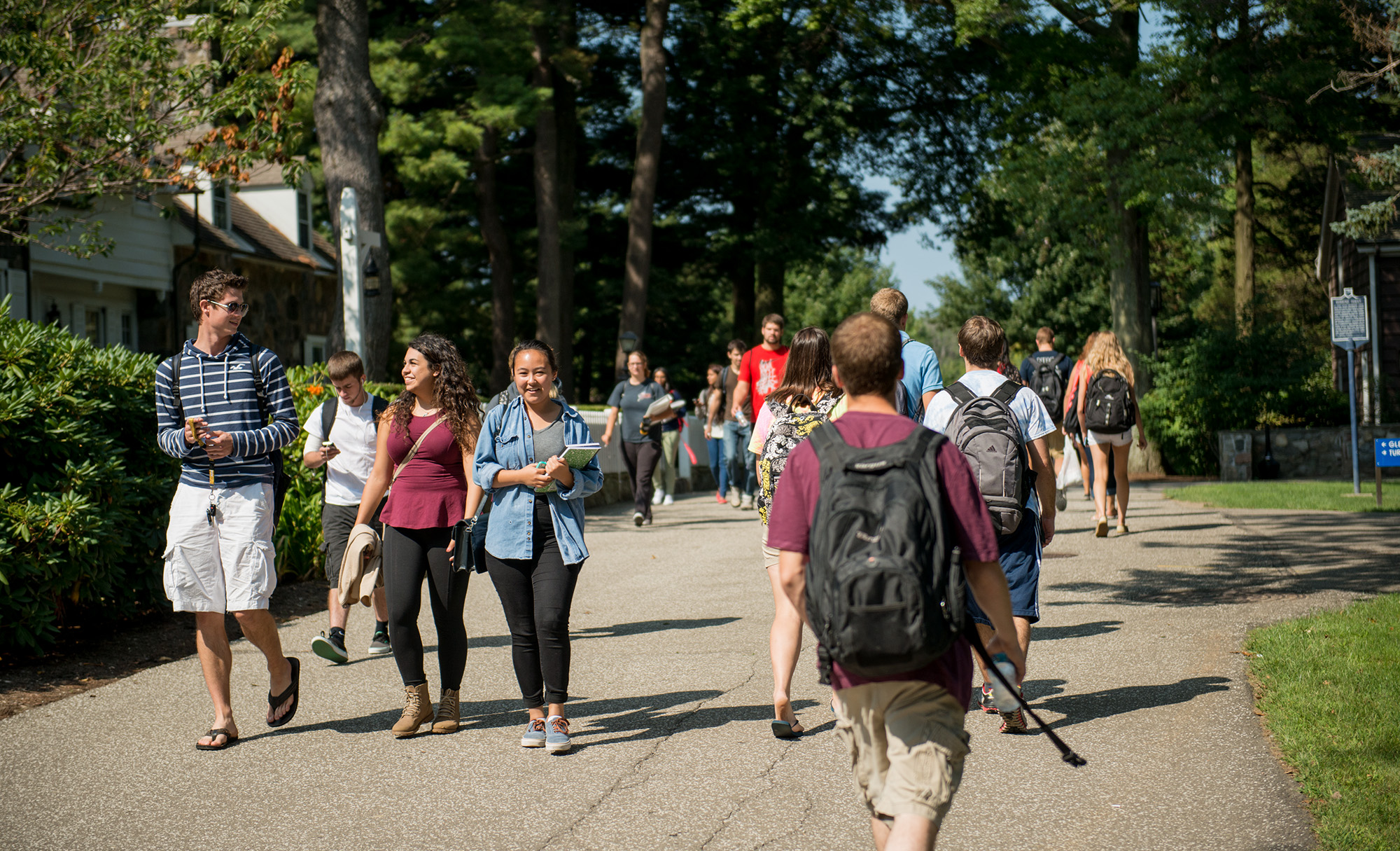 Students walking on campus between class times on a sunny day